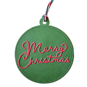 Green Tag with Merry Christmas written in red. Round and handmade by GEM Designs, LLC